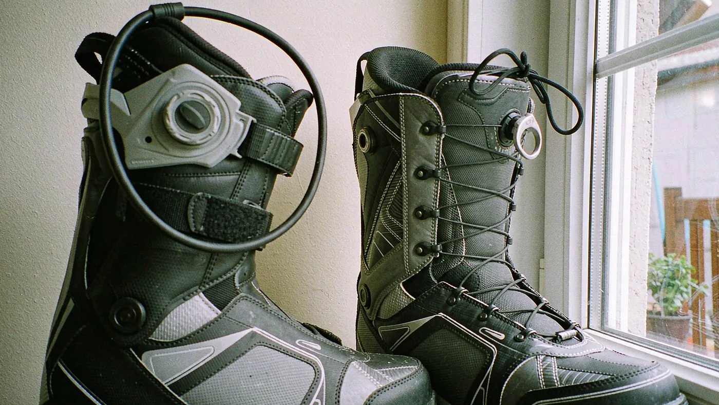 Side-by-side detail of a boot with a Boa dial and a boot with traditional laces tied at the cuff