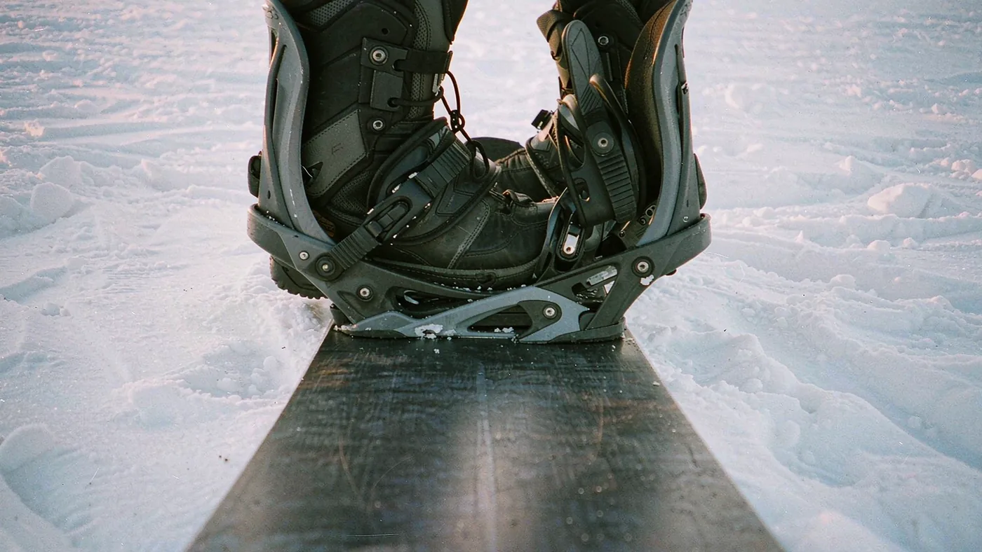 Looking down at a rider's own boots strapped into bindings showing the visible angle of both feet